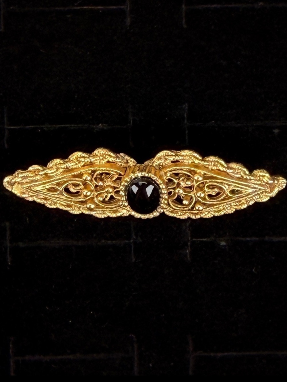 Elegant Goldtone Filigree Bar Brooch with Dark Center Accent